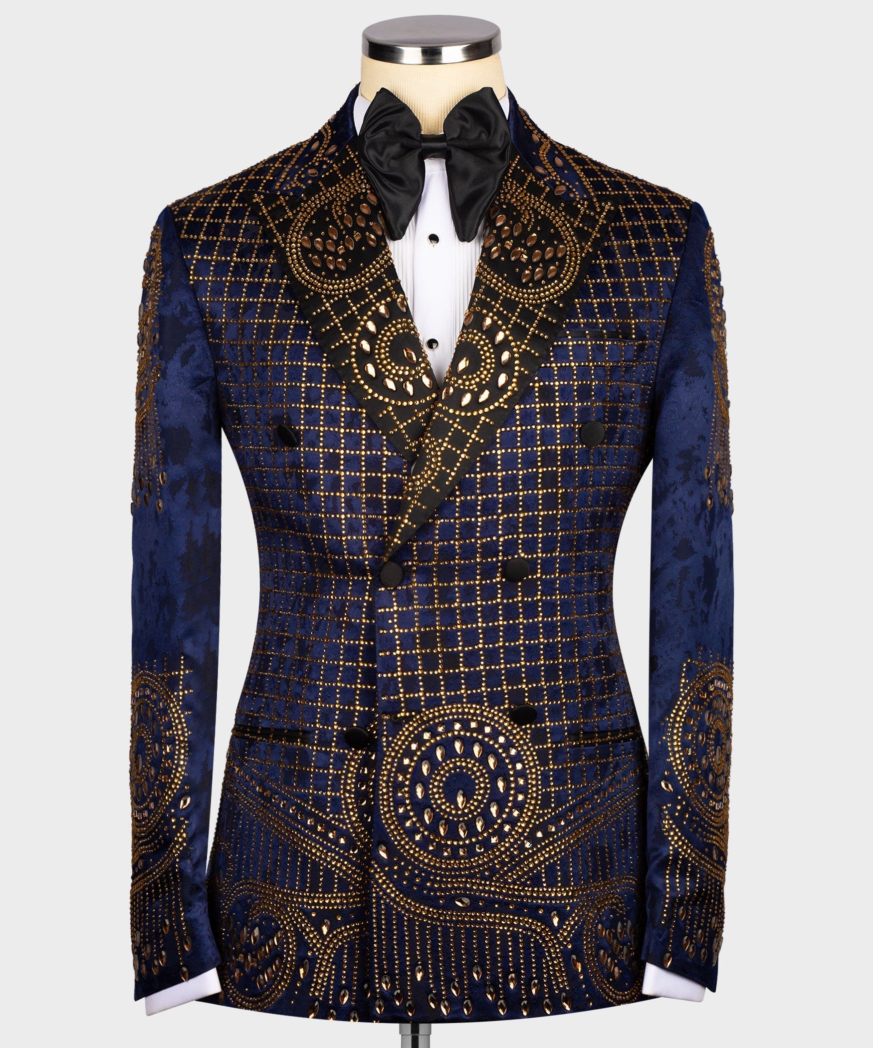 Blue tuxedo jacket with gold grid embroidery, ornate swirl motifs, black bow tie