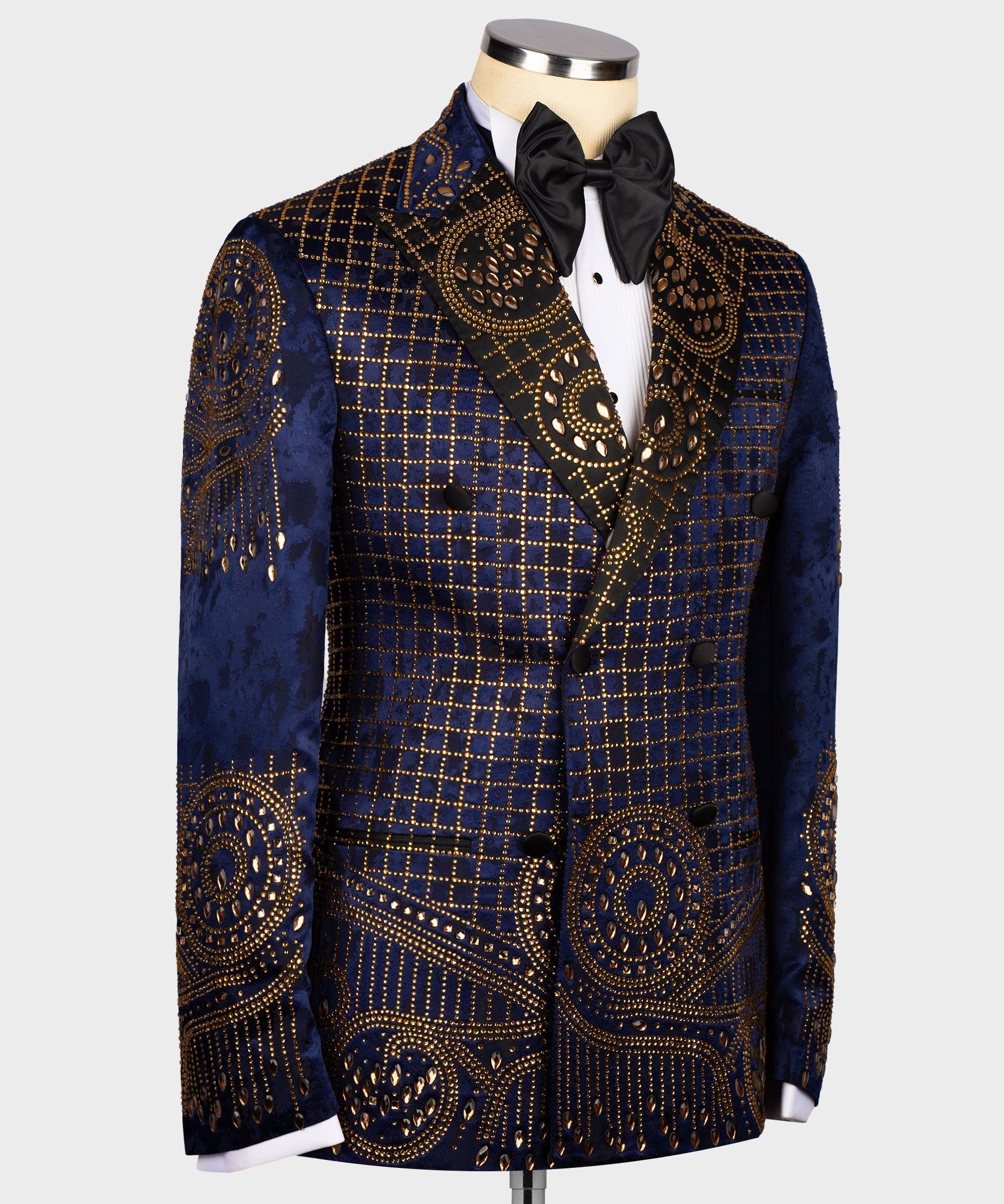 Blue tuxedo jacket side view with gold embroidered check grid and swirl motifs