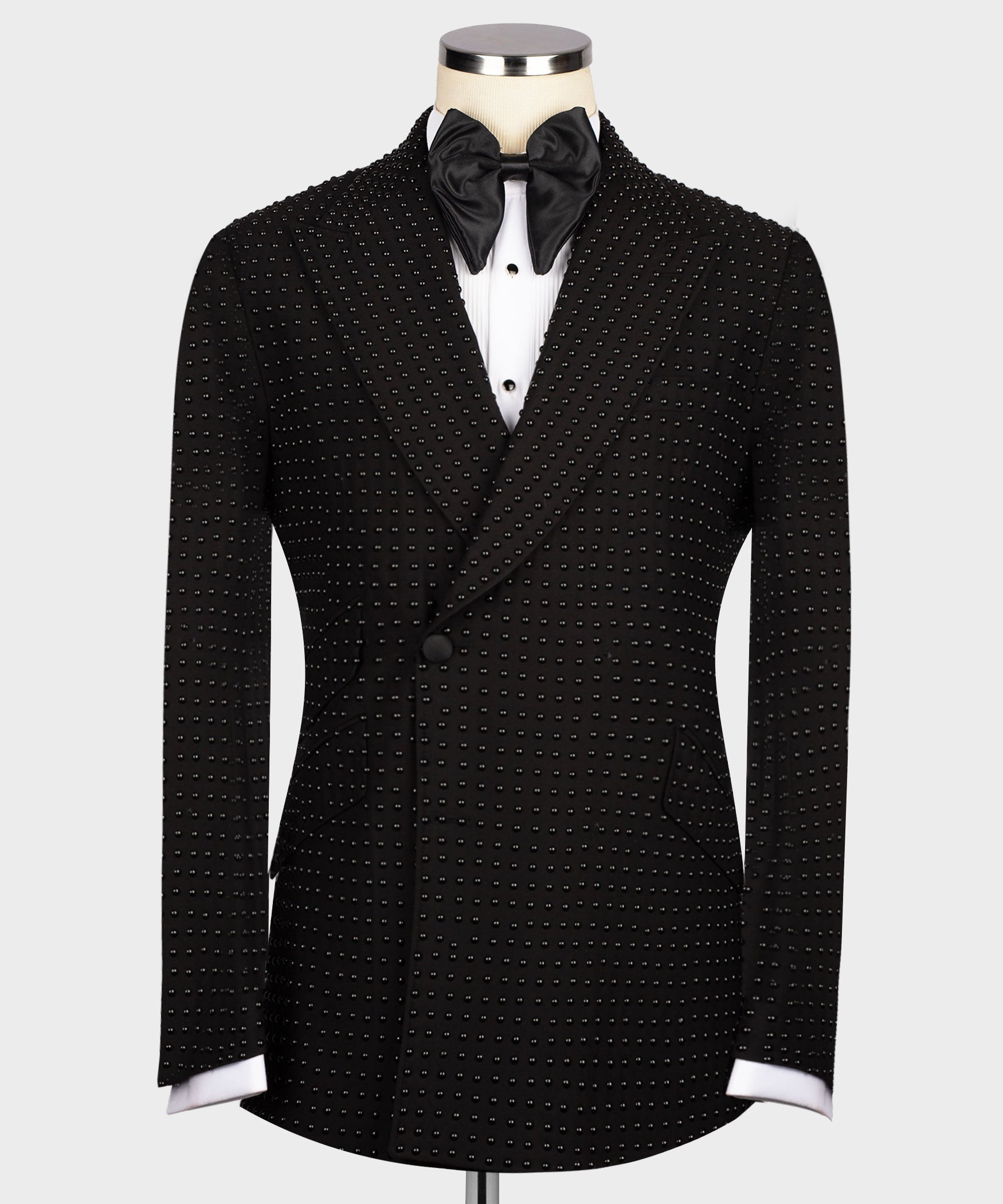 Black stone-embroidered tuxedo jacket with satin bow tie and white dress shirt