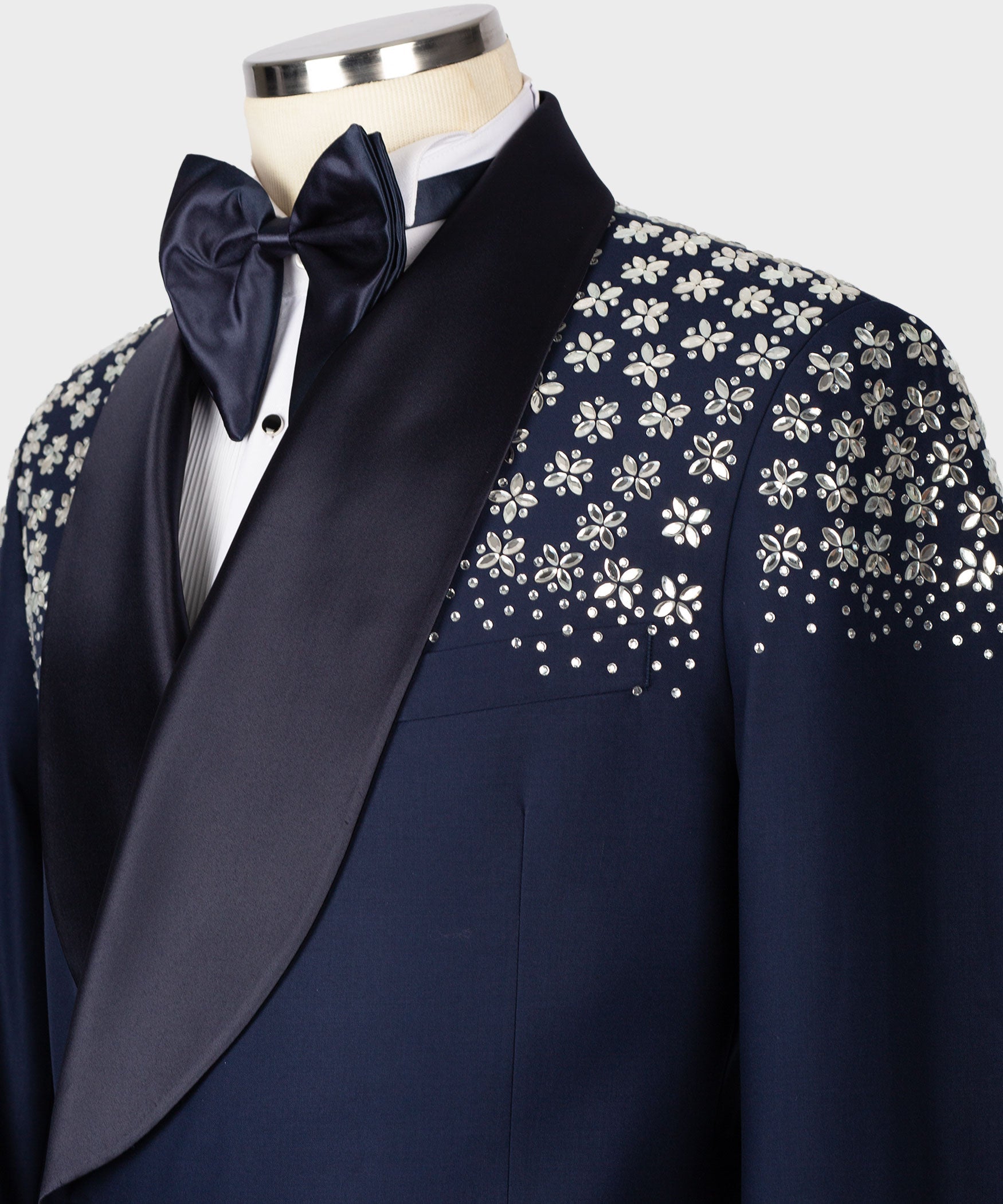 Close-up blue tuxedo lapel with floral stone embroidery and satin bow tie