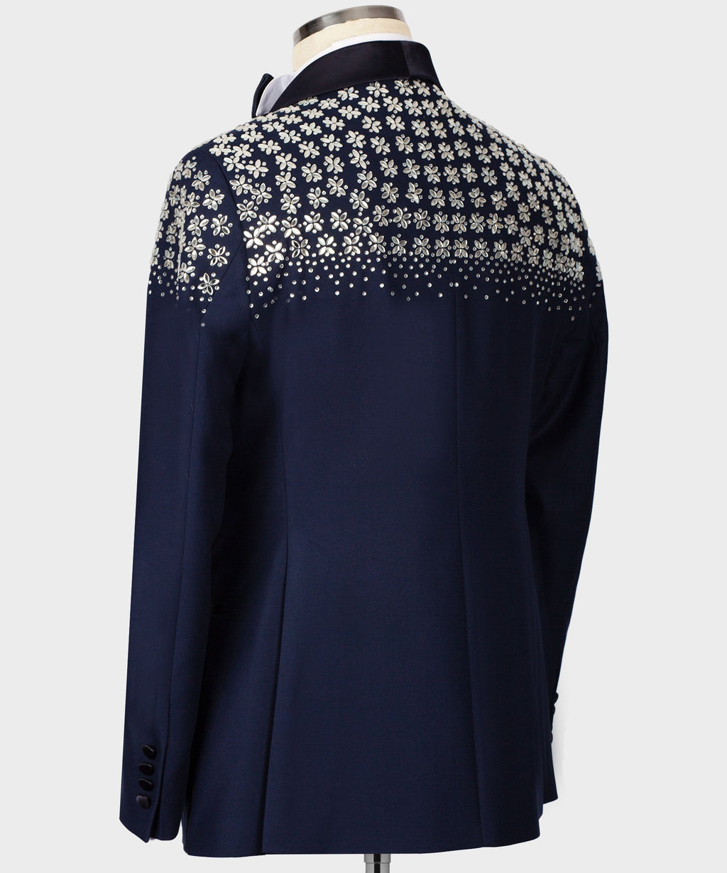 Blue tuxedo back view with floral stone embroidery near shoulders and mid-back