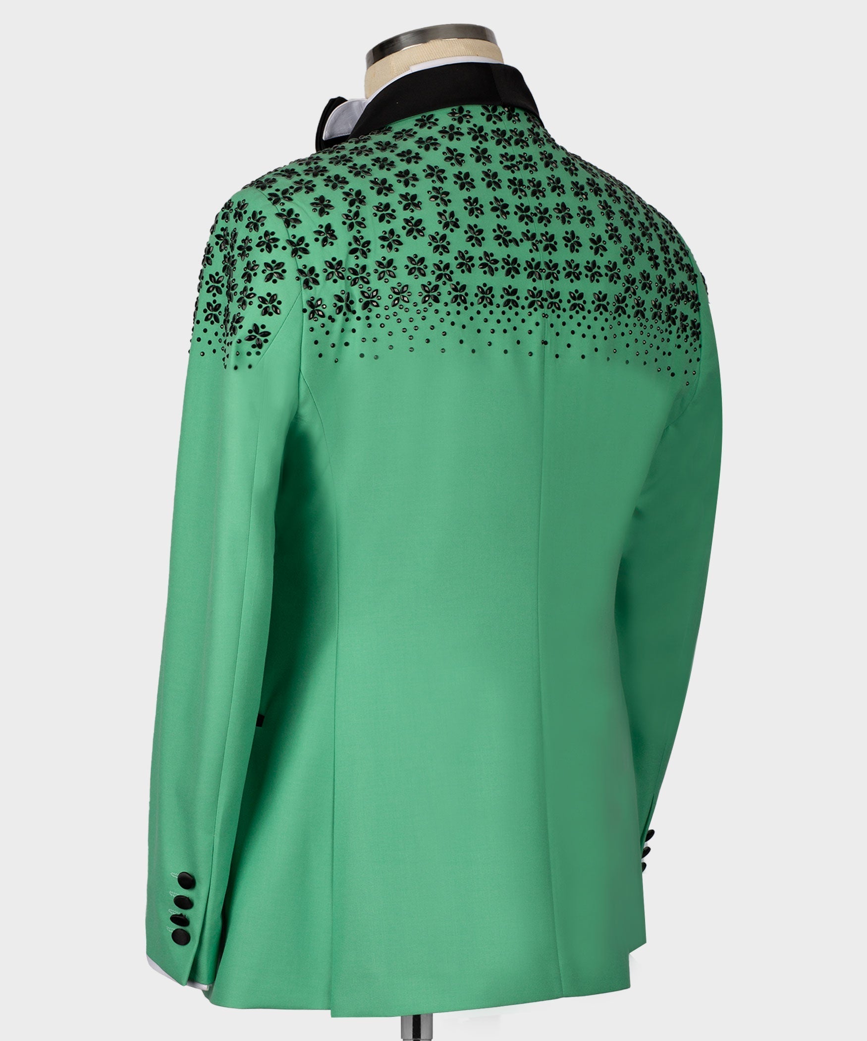 Light green tuxedo jacket back with black stone floral embroidery at shoulders and yoke.