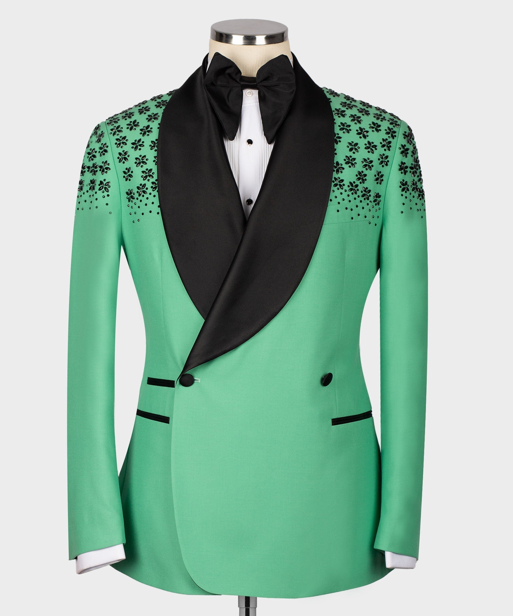 Light green silk tuxedo jacket with black shawl lapels, stone floral embroidery, bow tie.
