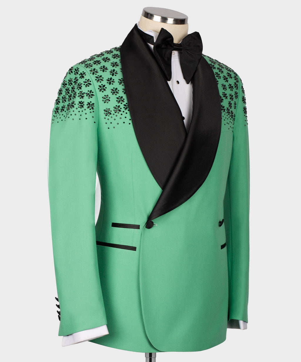 Light green tuxedo jacket with black shawl lapel and stone-embroidered floral pattern on shoulders.