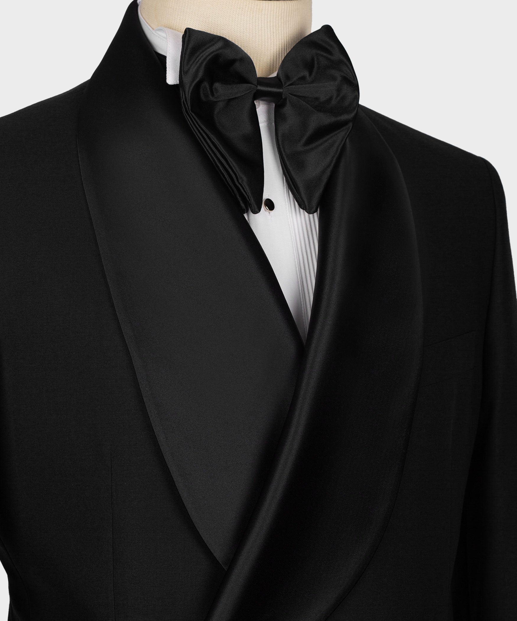 Close-up of black tuxedo shawl lapel and bow tie over white dress shirt