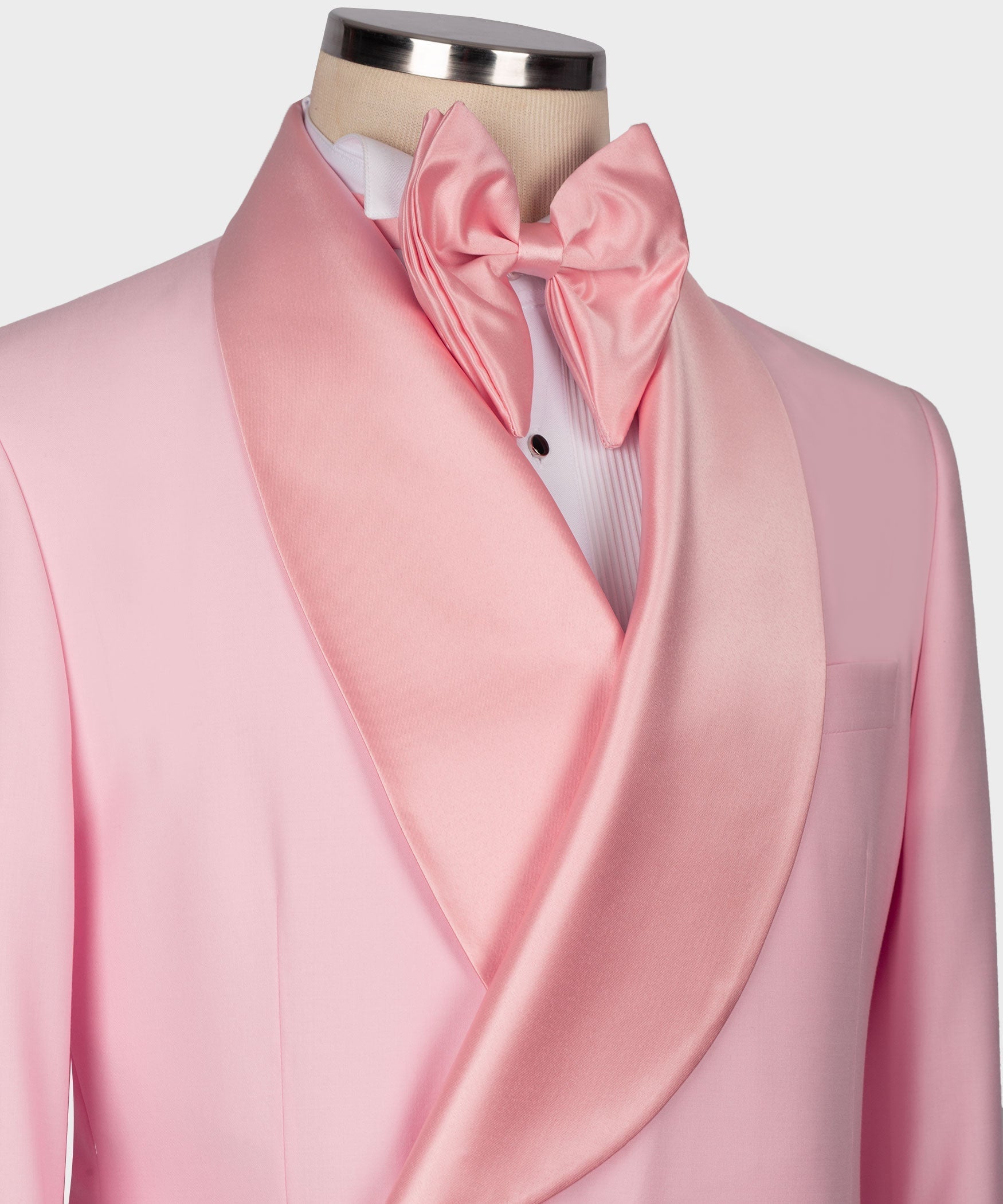 Close-up pink tuxedo with contrast satin bow and striped dress shirt peeking