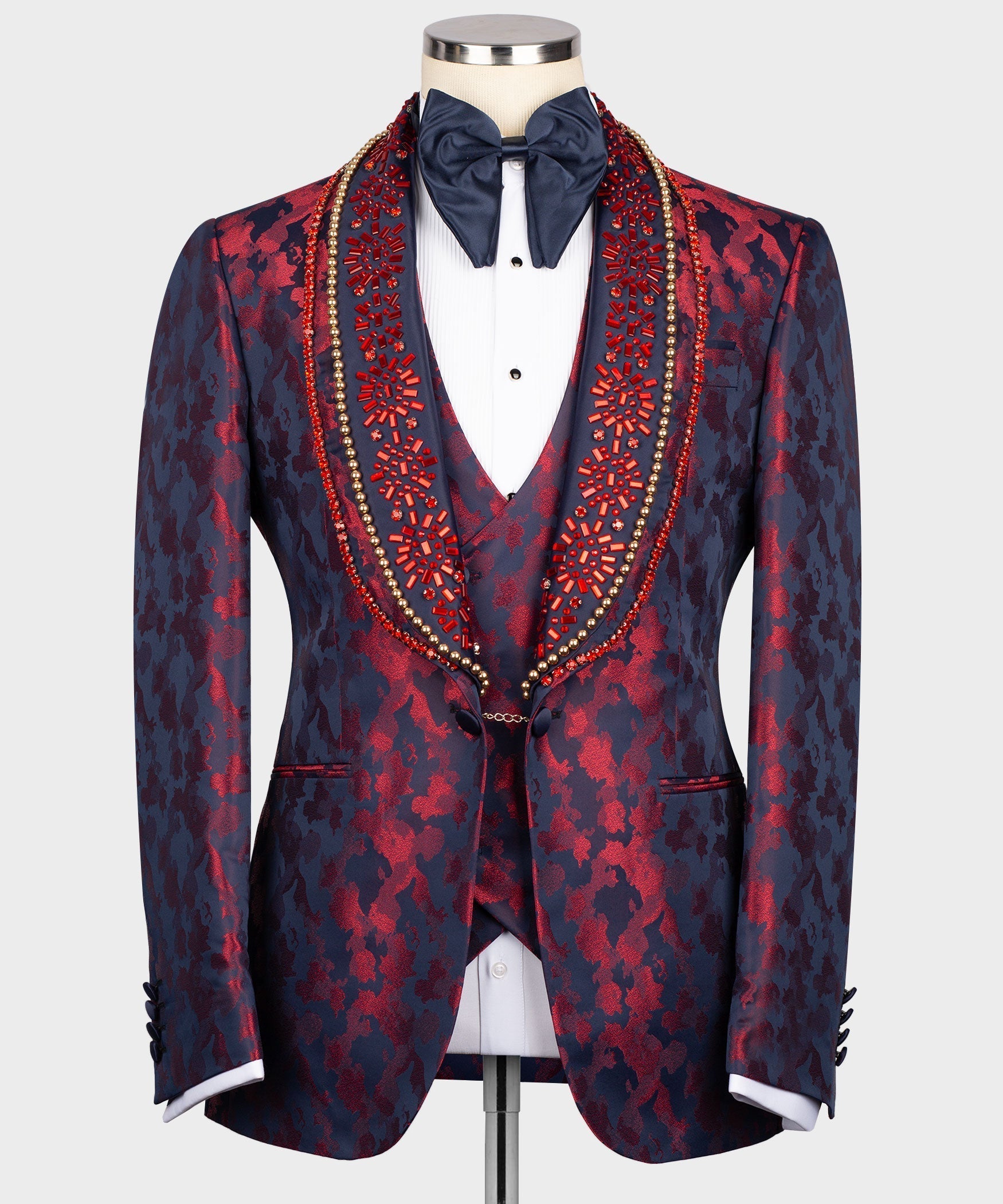 Navy tuxedo jacket with red patterned lapels, white shirt, navy bow tie