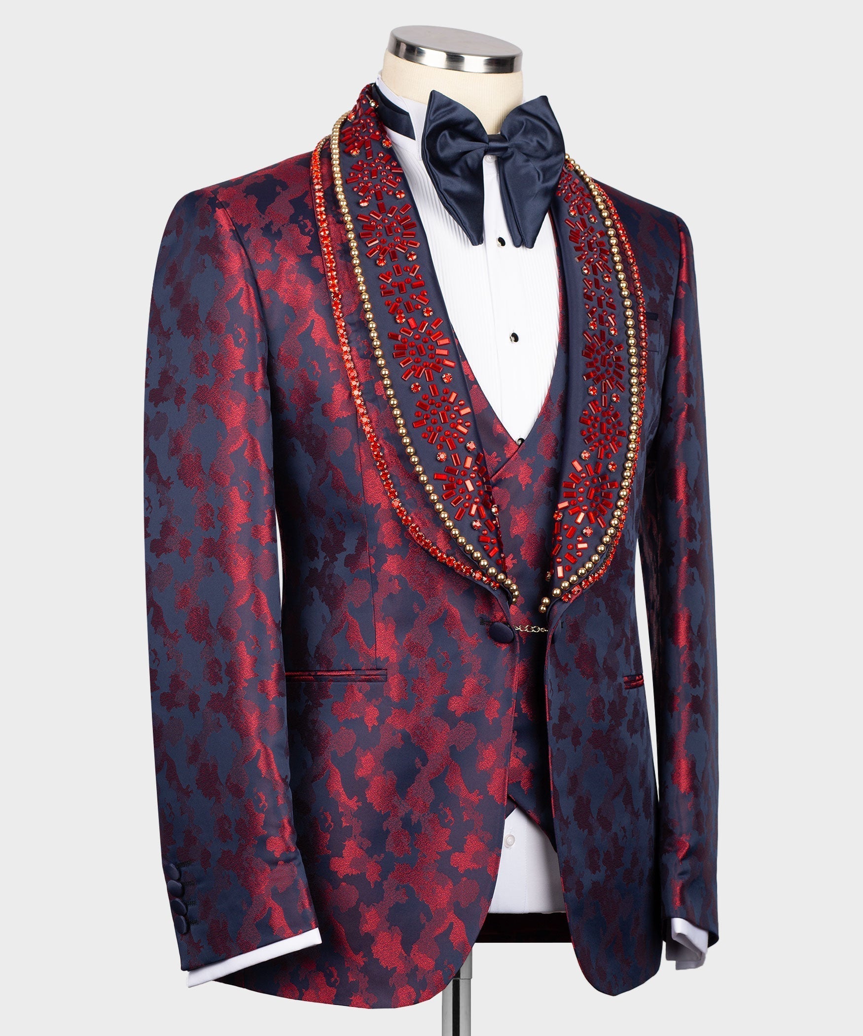 Navy tuxedo jacket with red pattern, decorative beaded trim, white shirt & bow tie
