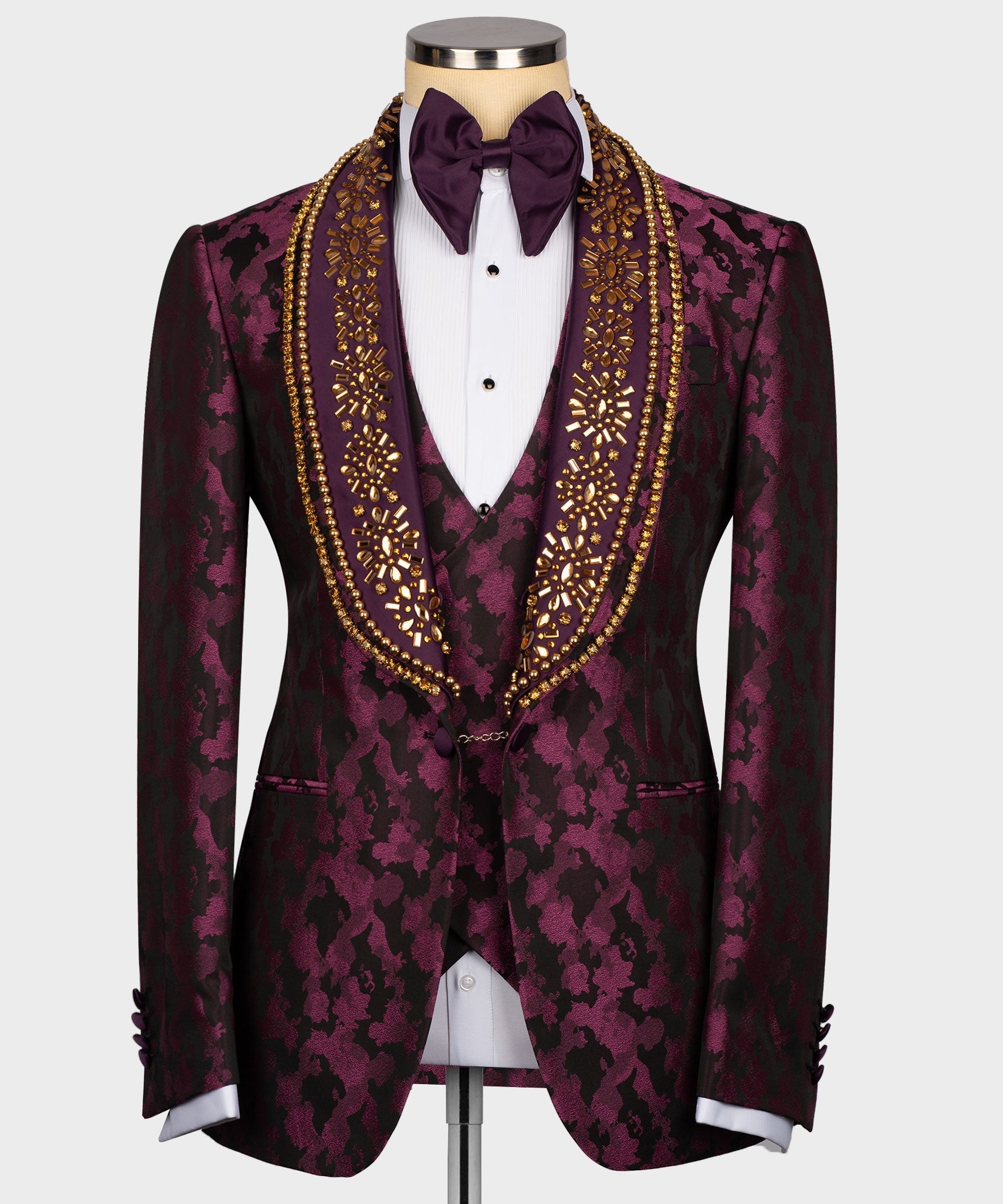 Stone-embellished tuxedo jacket with bow tie, white shirt, gold trim on burgundy print