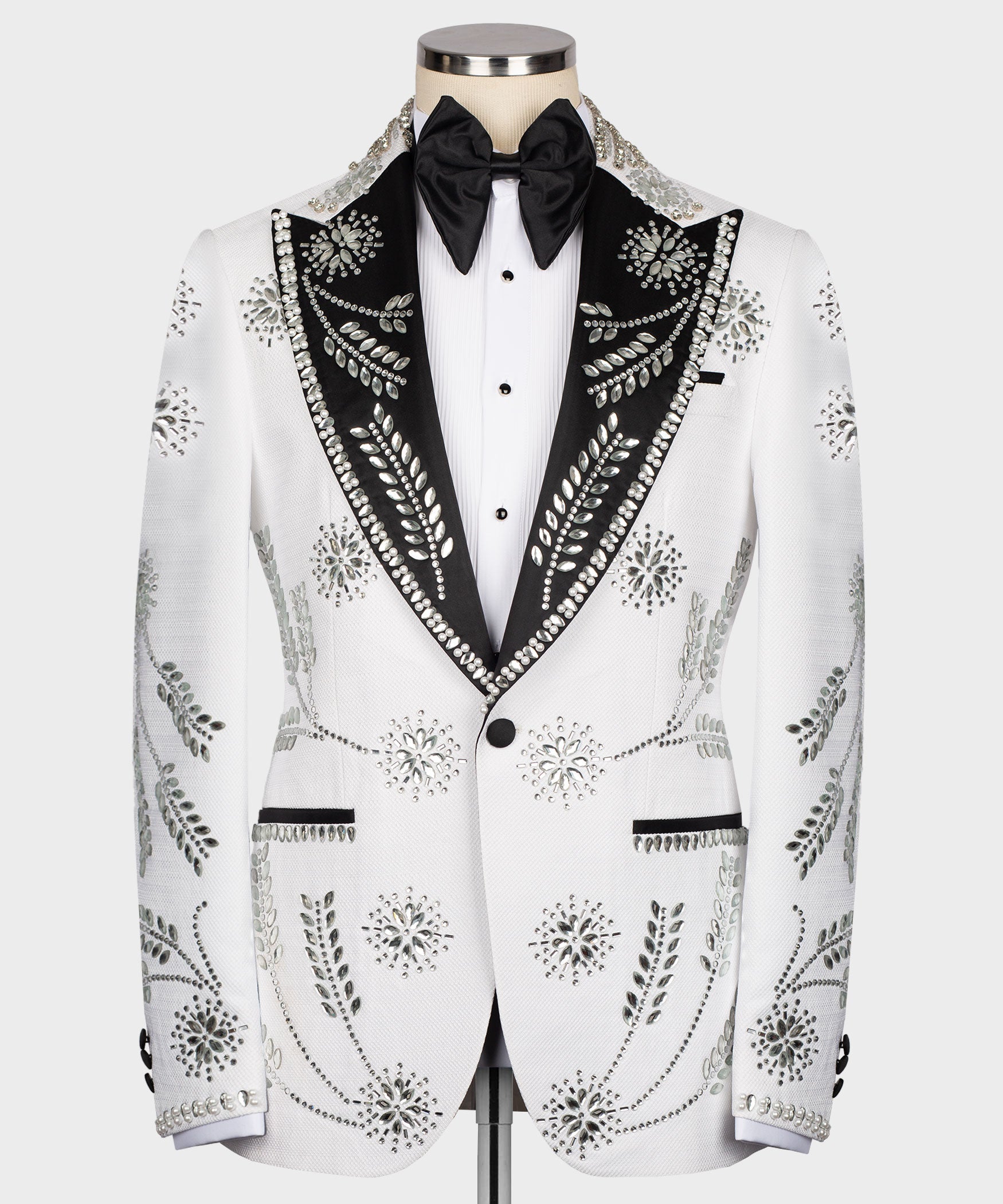 White tuxedo jacket with black satin lapels, bow tie, and rhinestone trim front