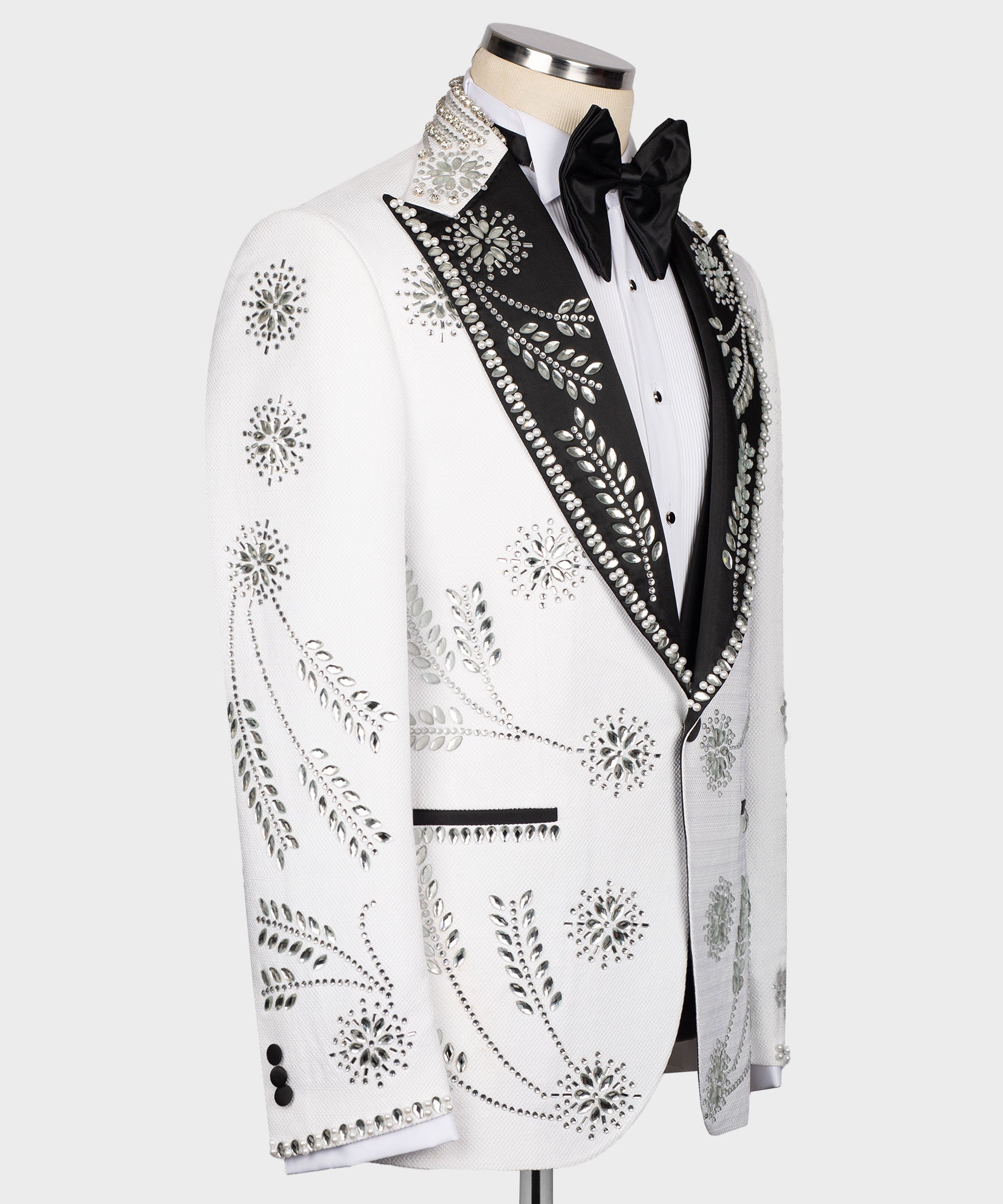 White tuxedo jacket side view with rhinestone floral motifs and jeweled trim lapel