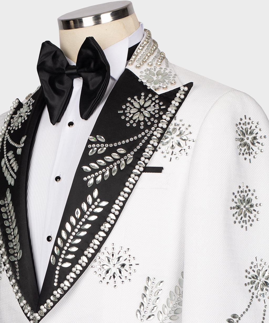 Close-up of black bow tie and jeweled black lapel on white tuxedo jacket