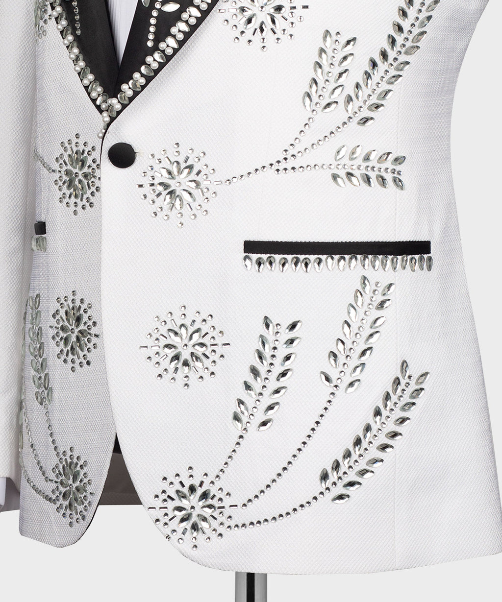 Close-up of white tuxedo jacket front with rhinestone buttons and beaded design panel