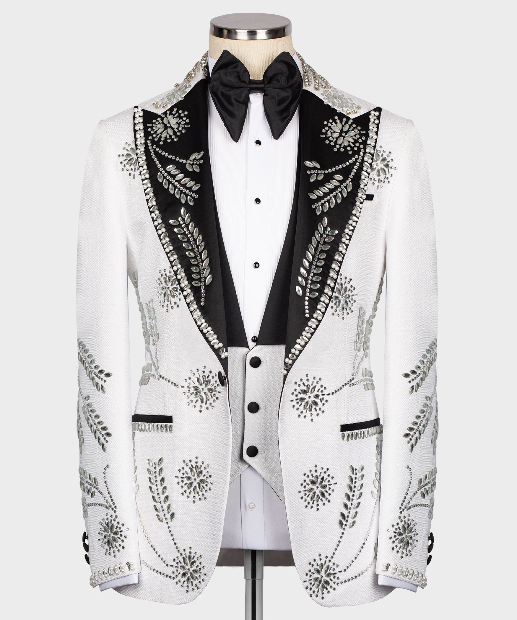 White tuxedo jacket front view with black lapels, rhinestone accents on pockets and vest