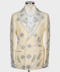 Cream tuxedo jacket with gemstone beaded embroidery, white bow tie, and satin lapels