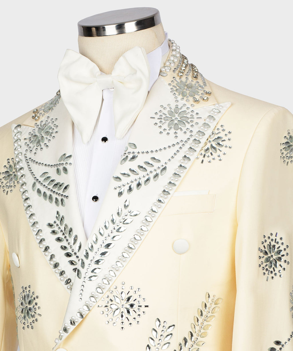 Cream tuxedo jacket neckline close-up with white bow tie and gemstone beaded lapel details