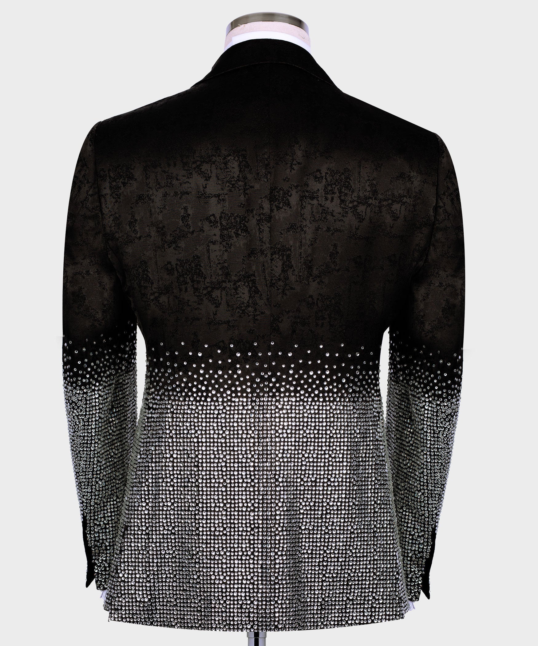 Black tuxedo jacket back view with silver rhinestone detailing at the hem