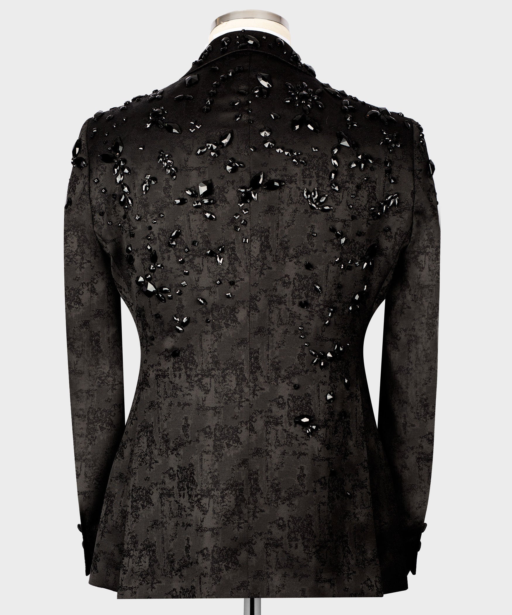 Back view of black tuxedo jacket with jeweled gemstone embroidery across shoulders