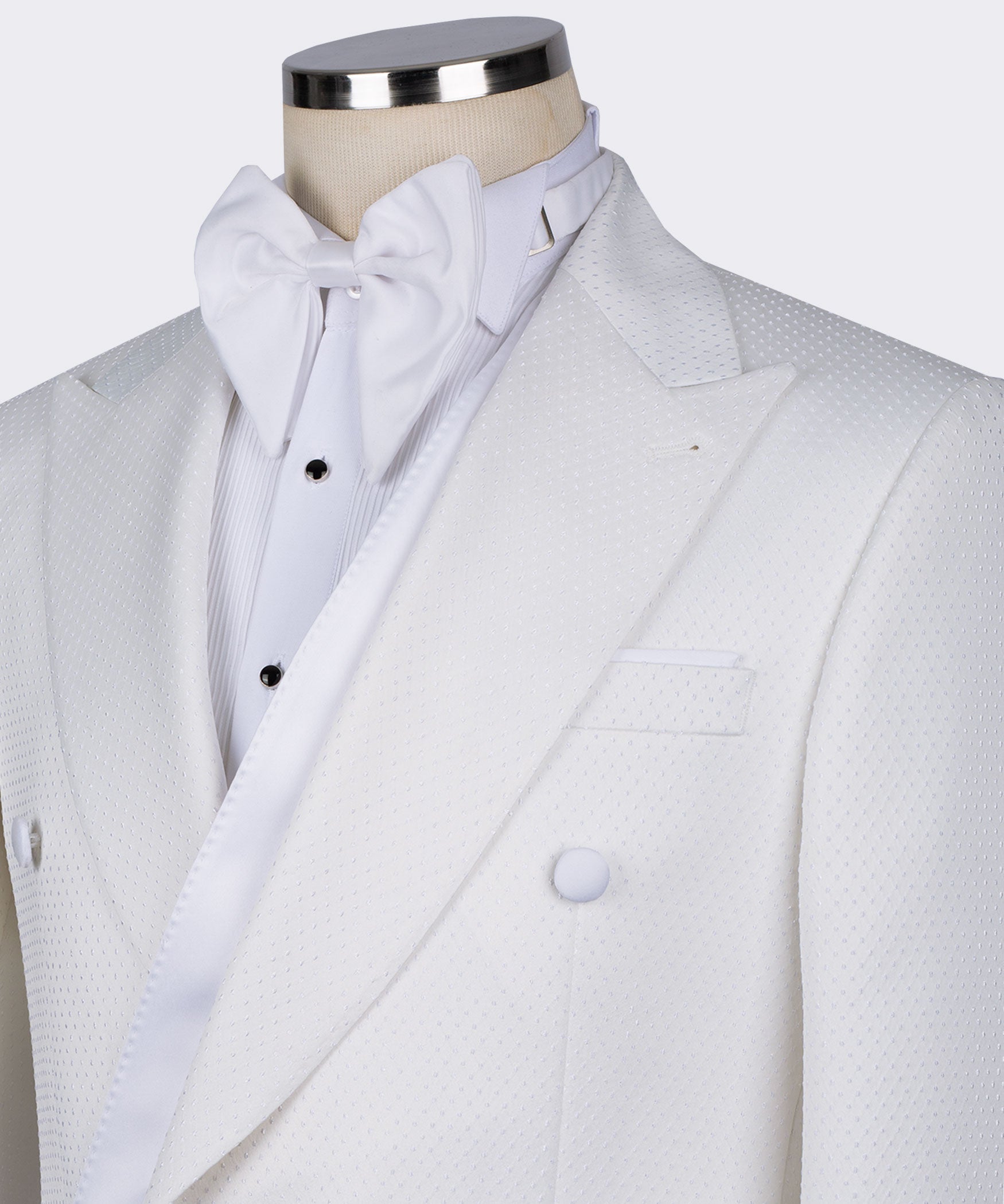 White double-breasted tuxedo with satin shawl lapels, bow tie neckline, textured fabric