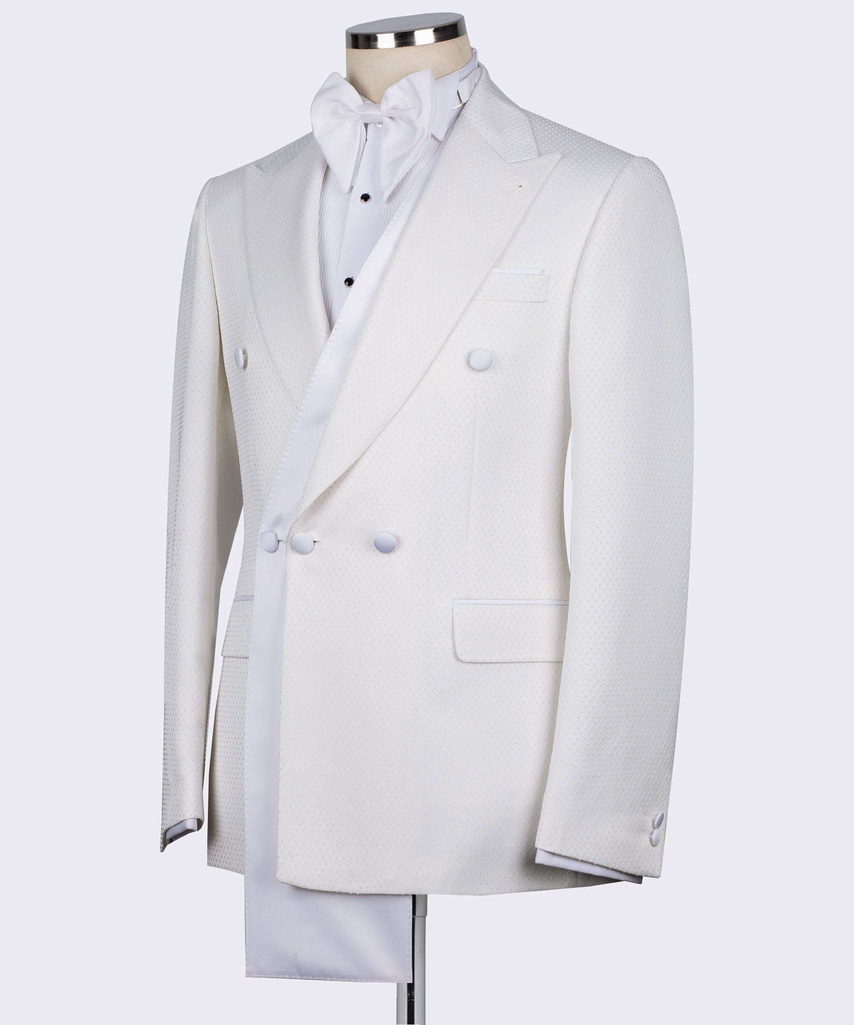 White tuxedo jacket on mannequin, double-breasted front, satin shawl collar, flap pocket