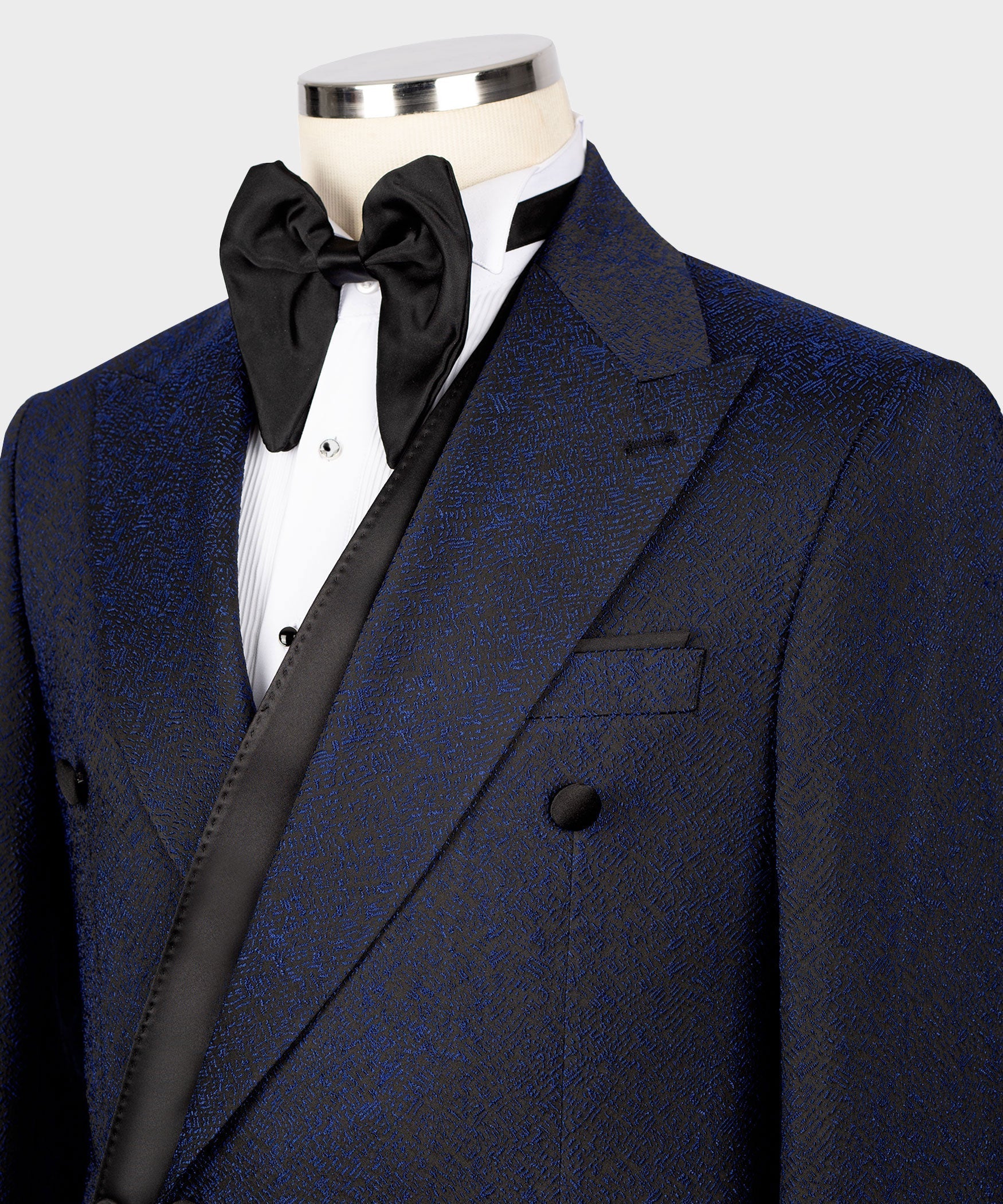 Close-up of dark navy tuxedo jacket with black satin bow collar and satin-trim lapel