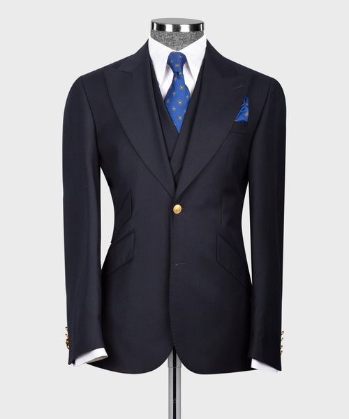 Dark navy blazer with gold buttons and blue patterned pocket square detail
