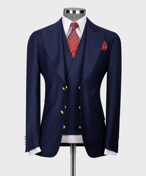 Navy blue vest suit jacket with gold buttons, red patterned tie and pocket square