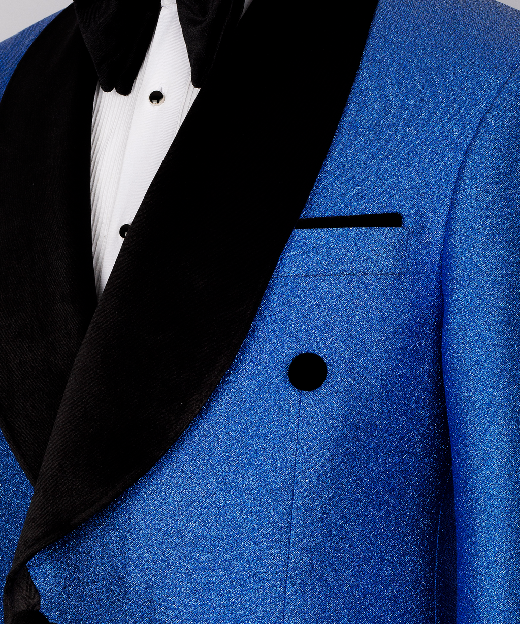 Close-up blue velvet blazer with black shawl lapel, double-breast buttons, welt pocket