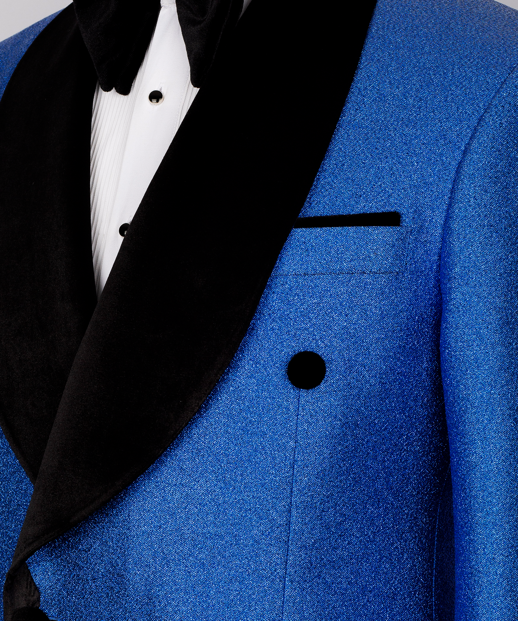 Close-up blue velvet blazer with black shawl lapel, double-breast buttons, welt pocket