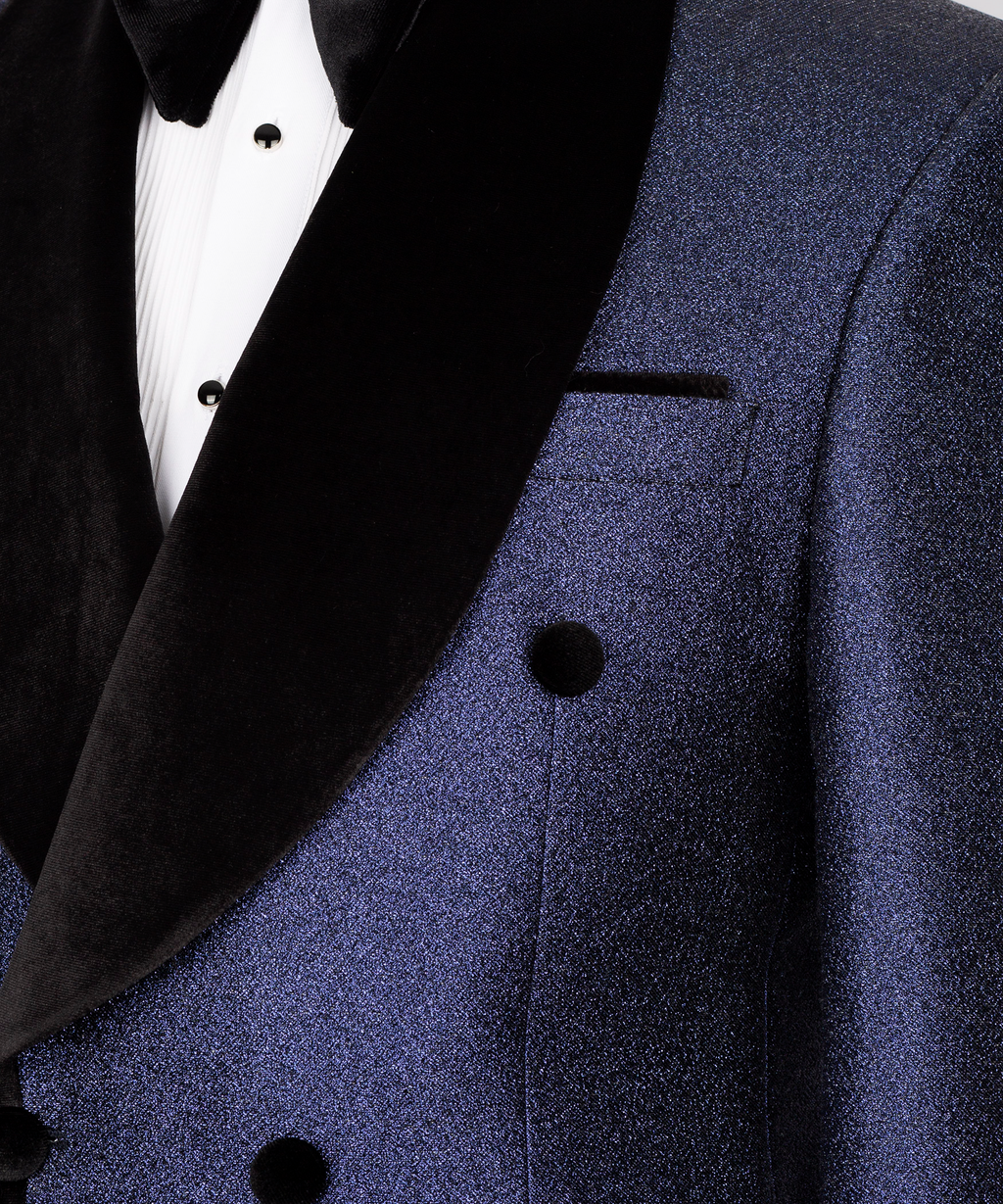 Close-up: black velvet shawl lapel and dark blue suit pocket with matching black buttons