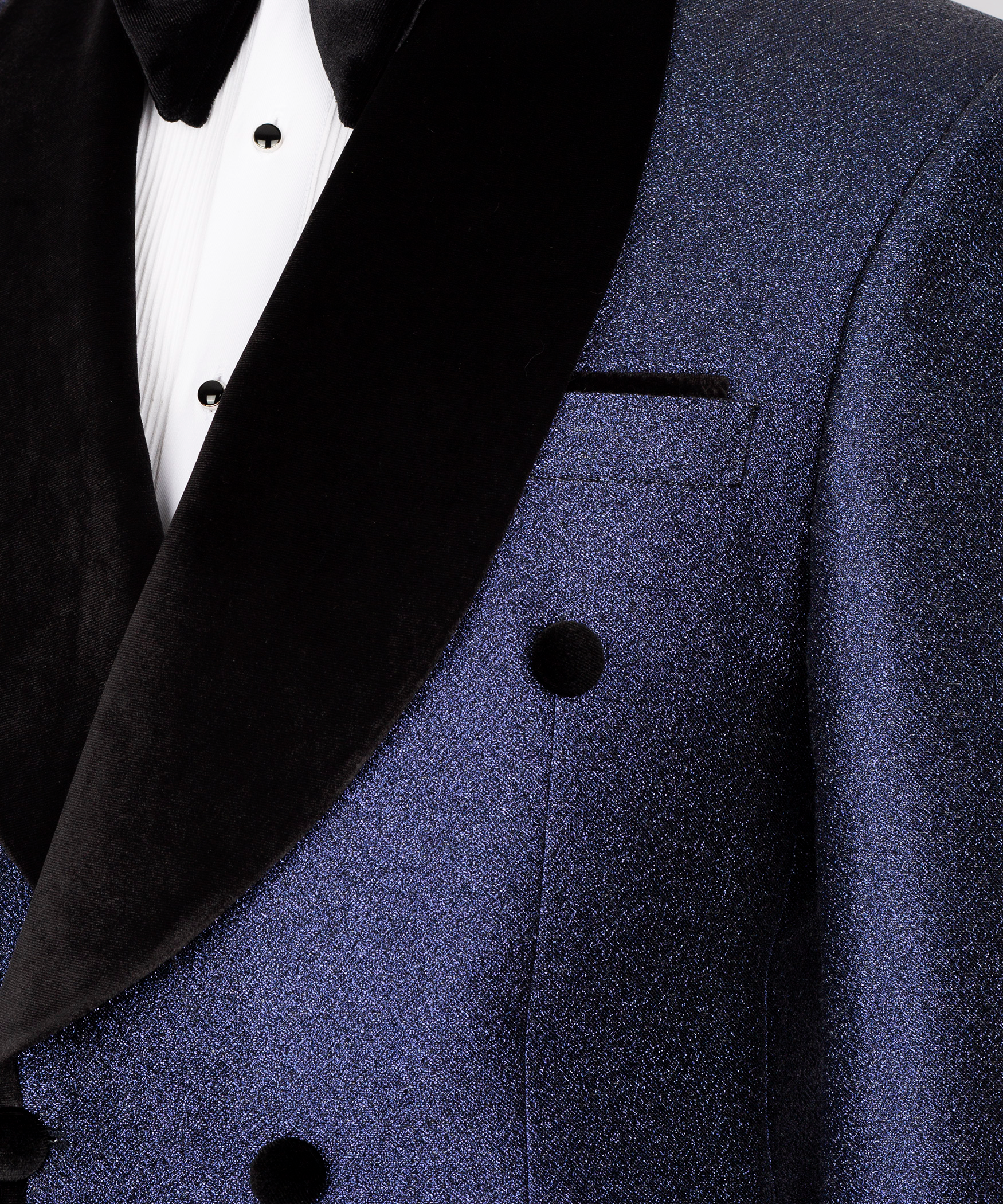 Close-up: black velvet shawl lapel and dark blue suit pocket with matching black buttons