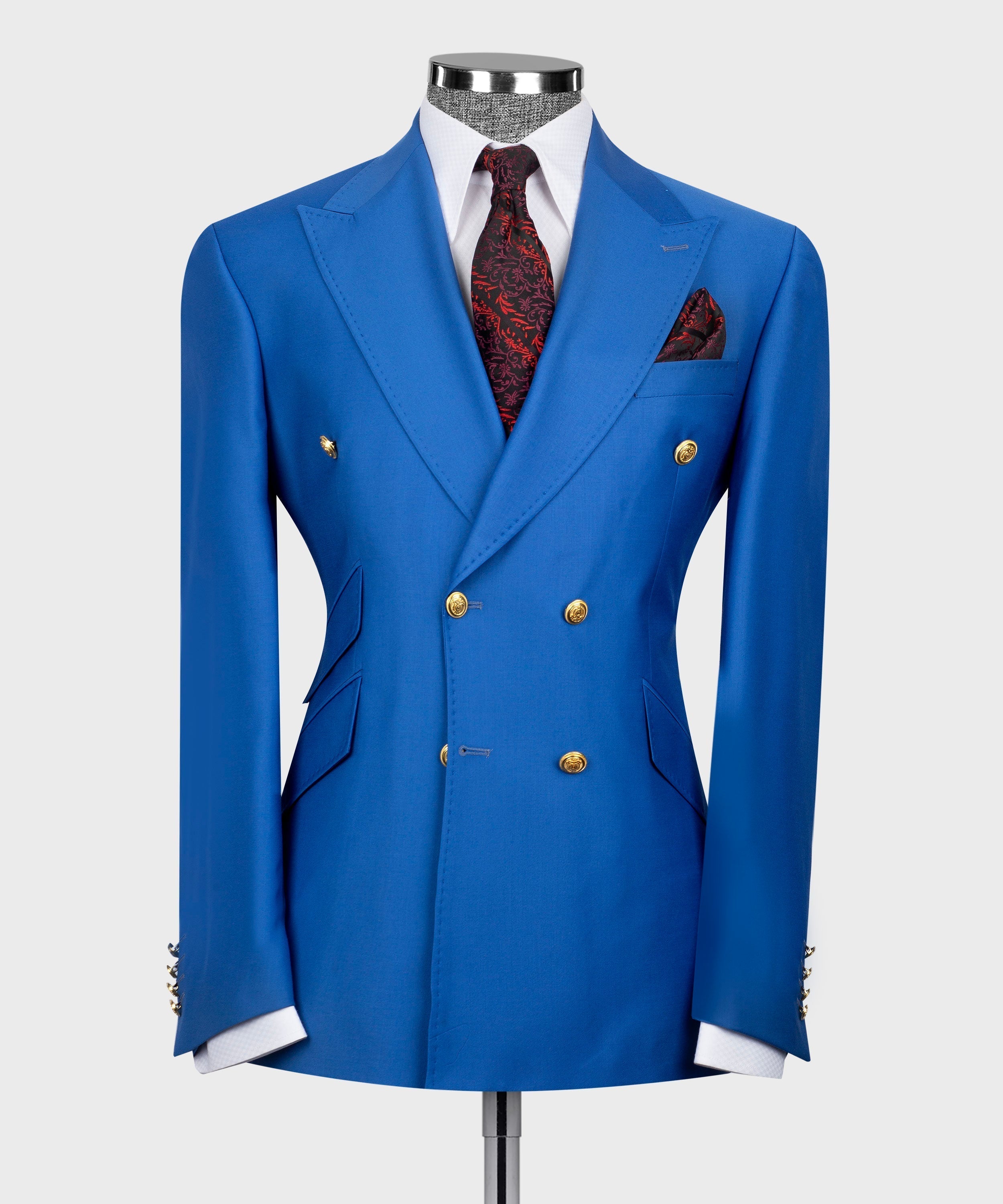 Blue double-breasted suit jacket with gold buttons, white shirt, red patterned pocket square