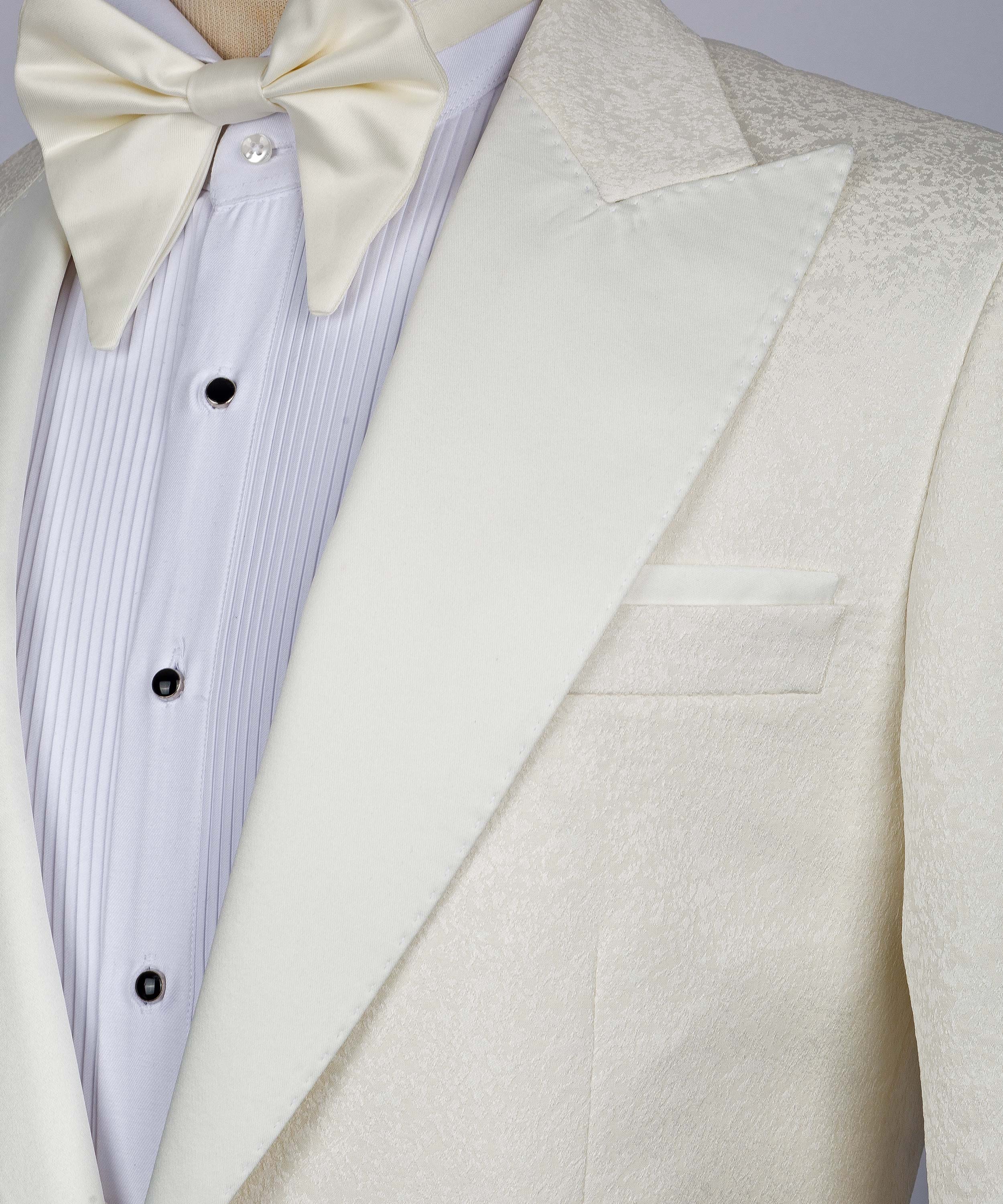 Cream satin lapel detail with inner pocket and bow tie over striped shirt