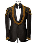 Black tuxedo jacket with gold bead embroidery, white vest, and black satin bow tie