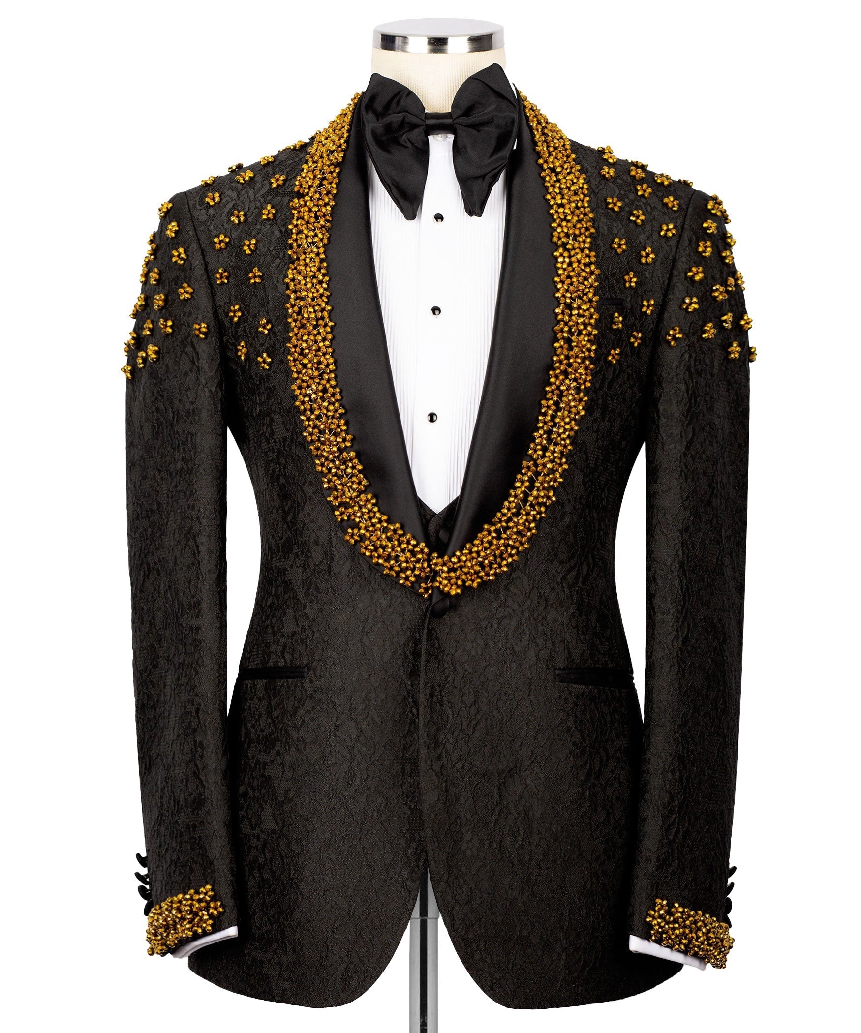 Black tuxedo jacket with gold bead embroidery, white vest, and black satin bow tie