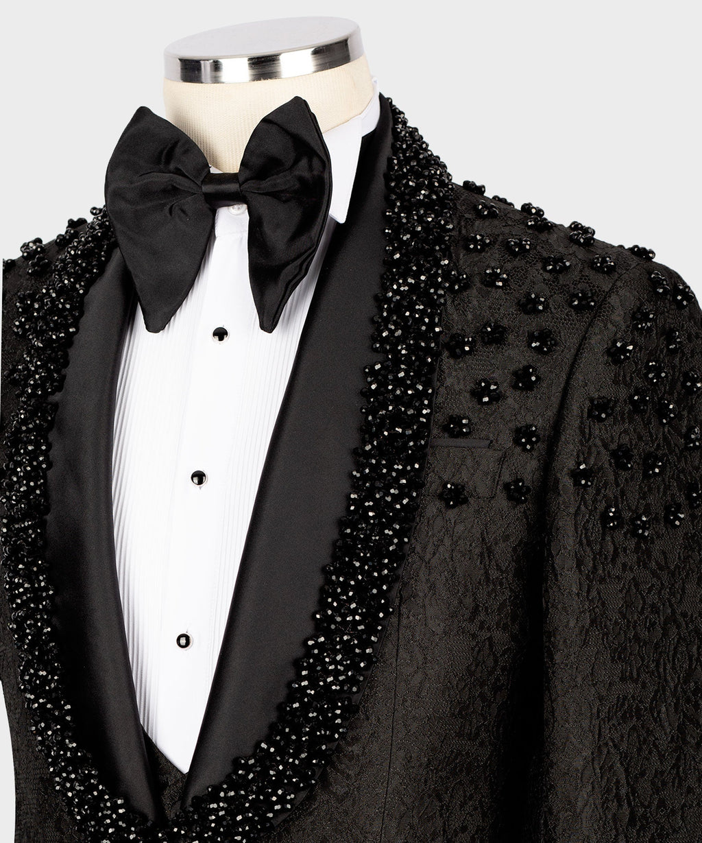 Close-up of black tuxedo lapel with sparkling sequin embroidery and oversized bow