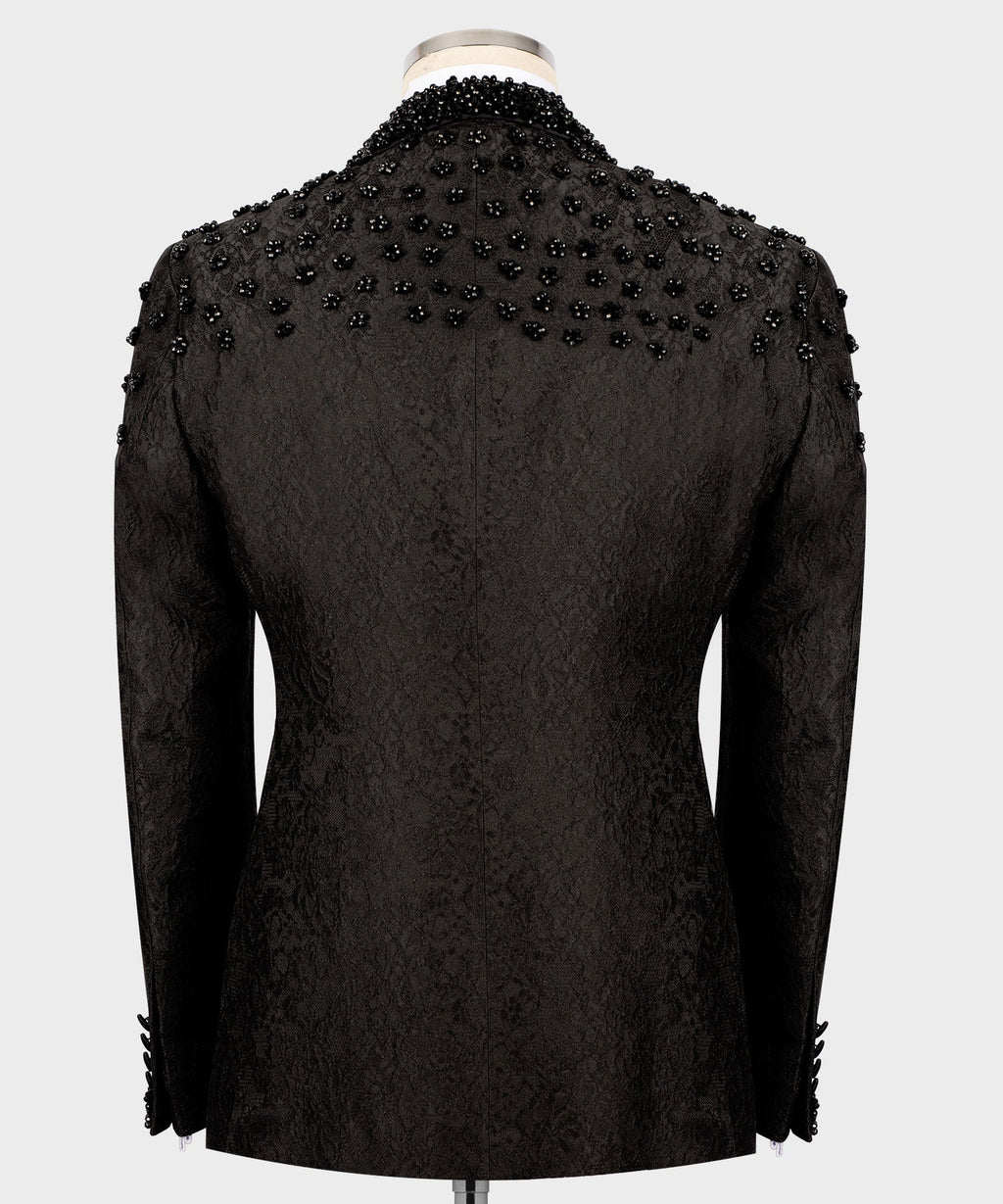 Back view of black tuxedo jacket with allover sequin embroidery, tailored seams