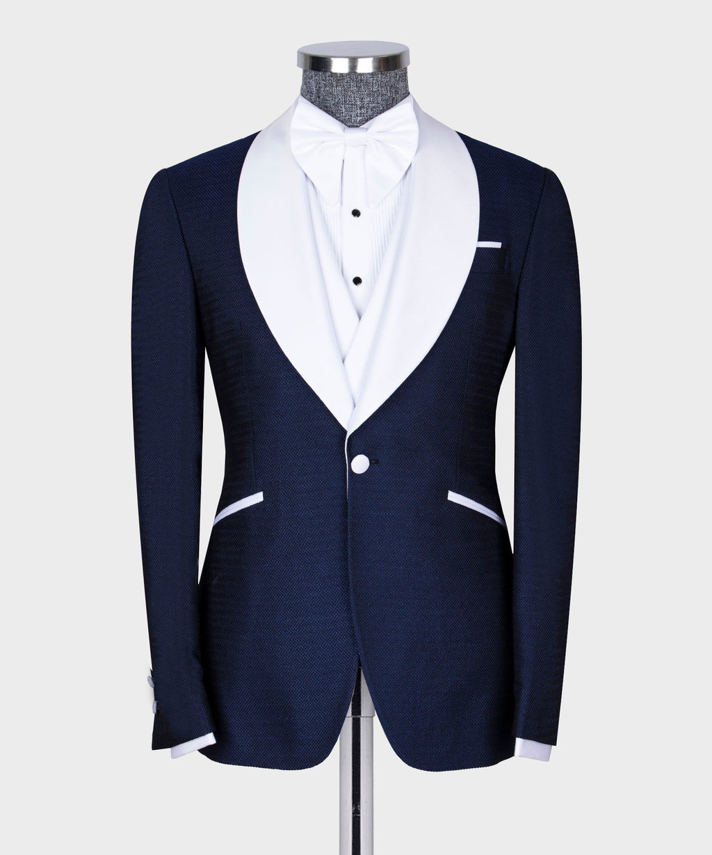 Navy tuxedo jacket with white bow tie and matching waistcoat on dress shirt