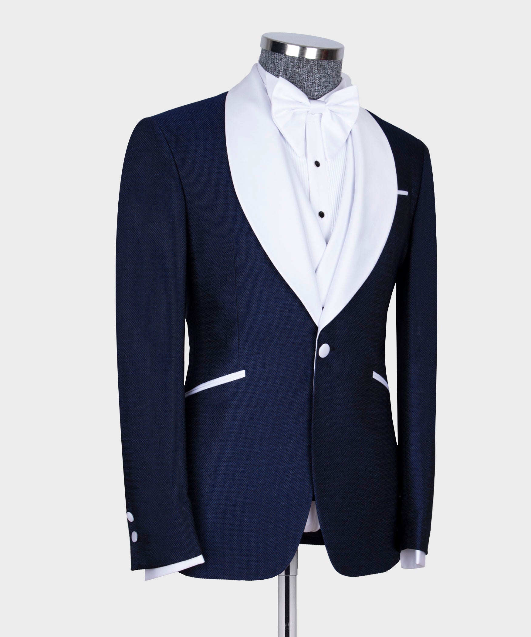 Navy tuxedo jacket and waistcoat set with white bow tie, three-piece formal look