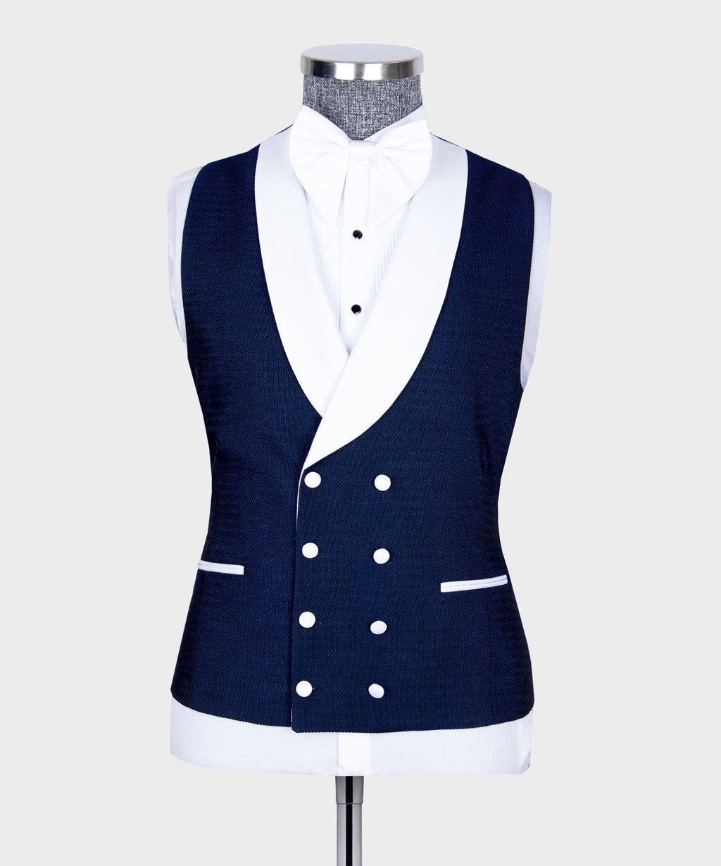 Navy tuxedo waistcoat with white accents and double-breasted buttons over dress shirt