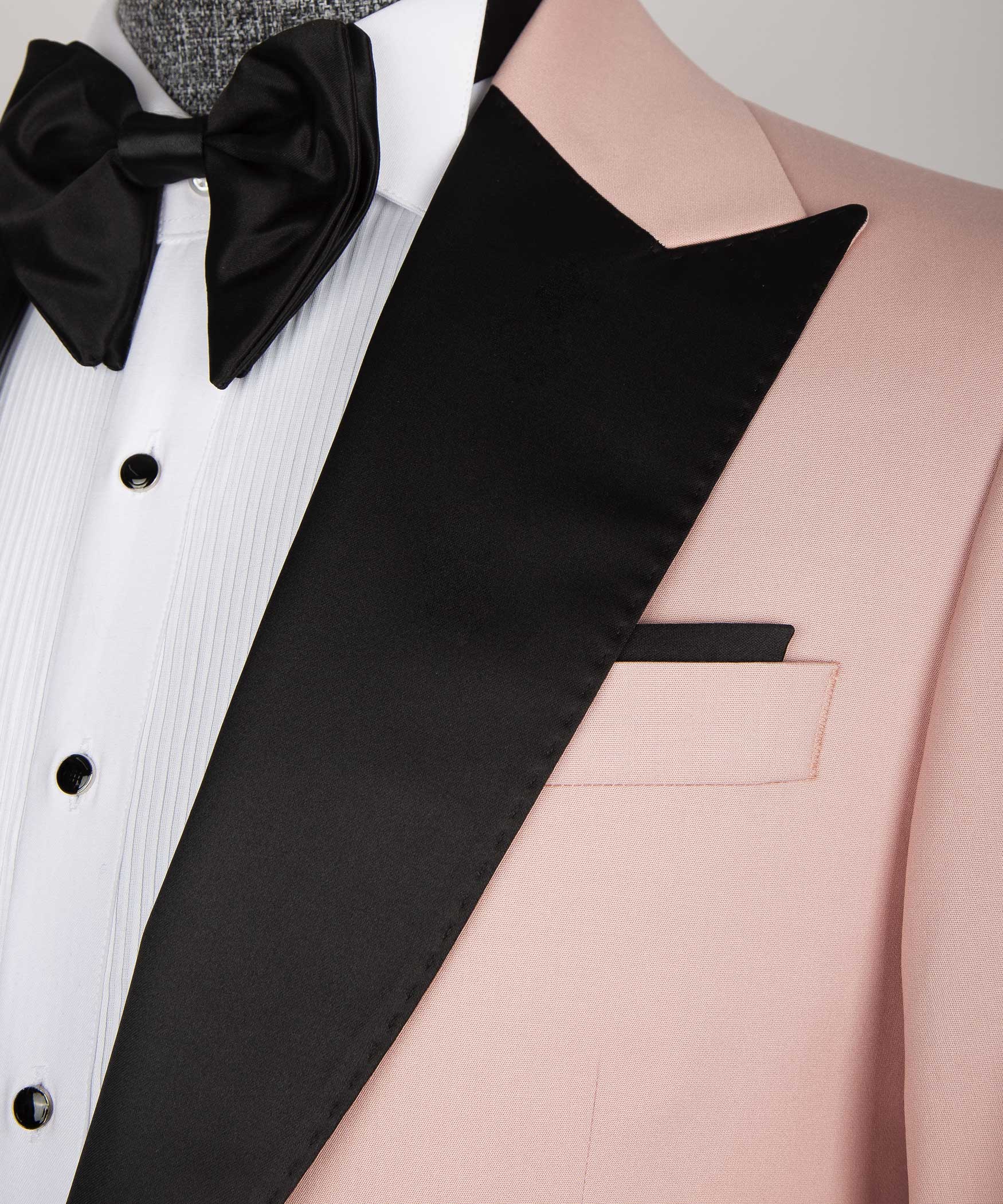 Close-up: black satin lapel edge, pink jacket pocket, and white shirt front
