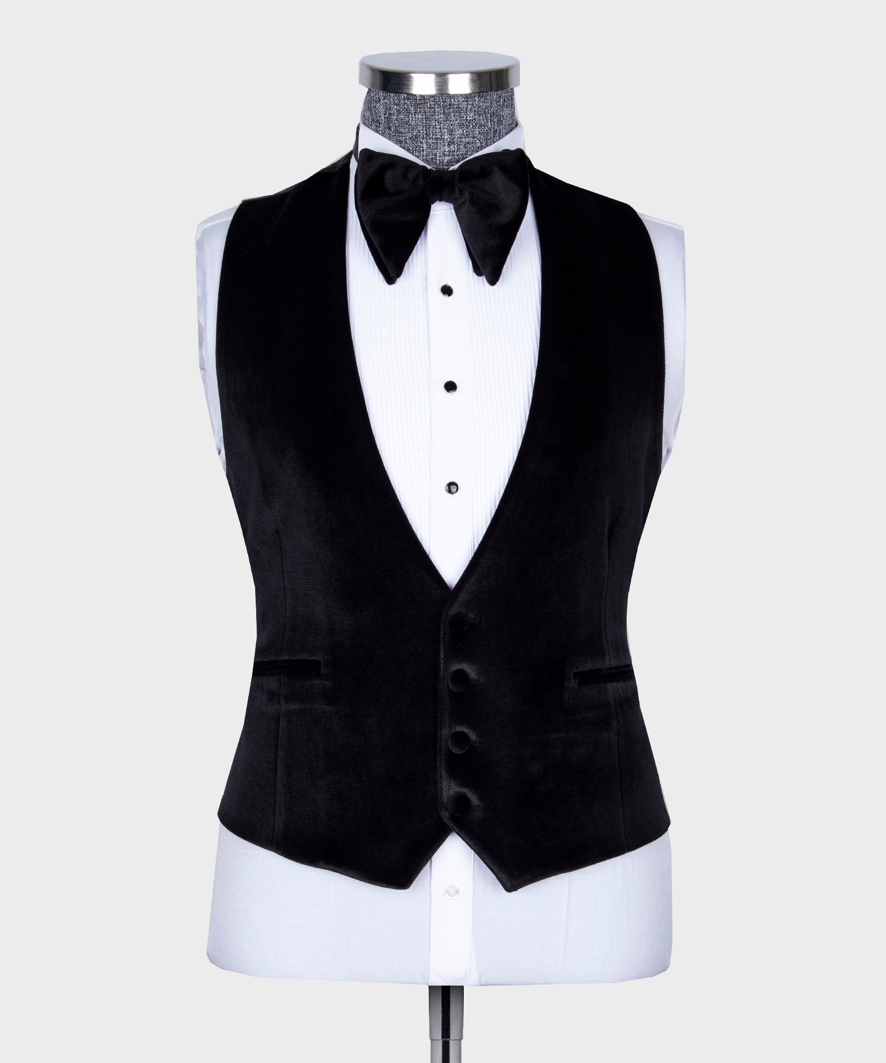 Black velvet tuxedo vest with satin lapels, white shirt, and black bow tie