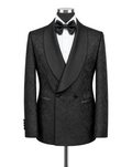 A black double-breasted tuxedo jacket with a subtle jacquard paisley pattern, styled on a mannequin with a white dress shirt and black bow tie against a light gray background.