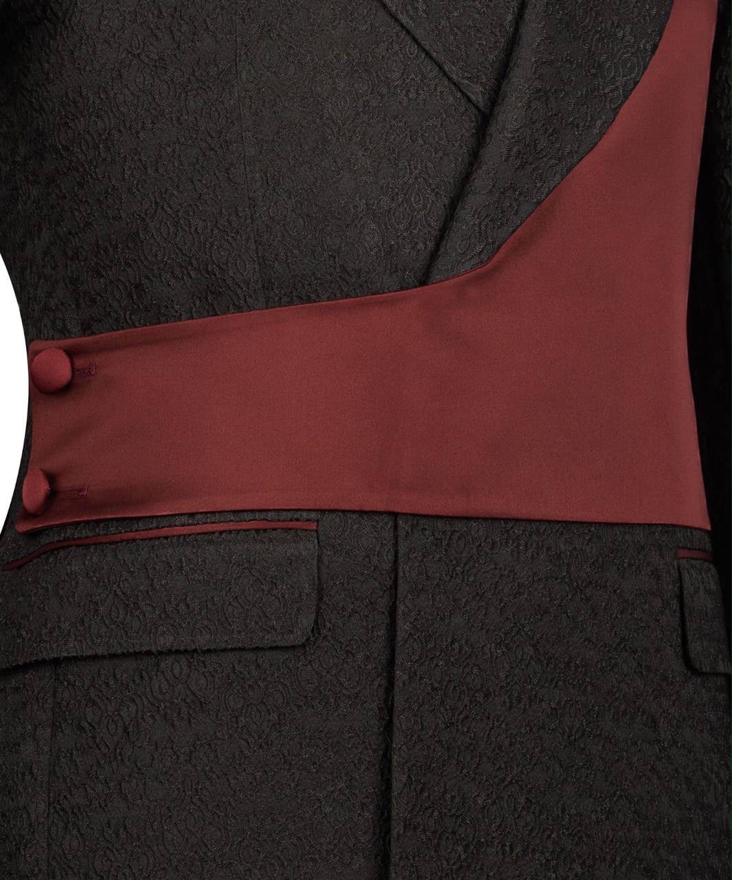 Close-up of a dark gray suit with a red lining and buttons.