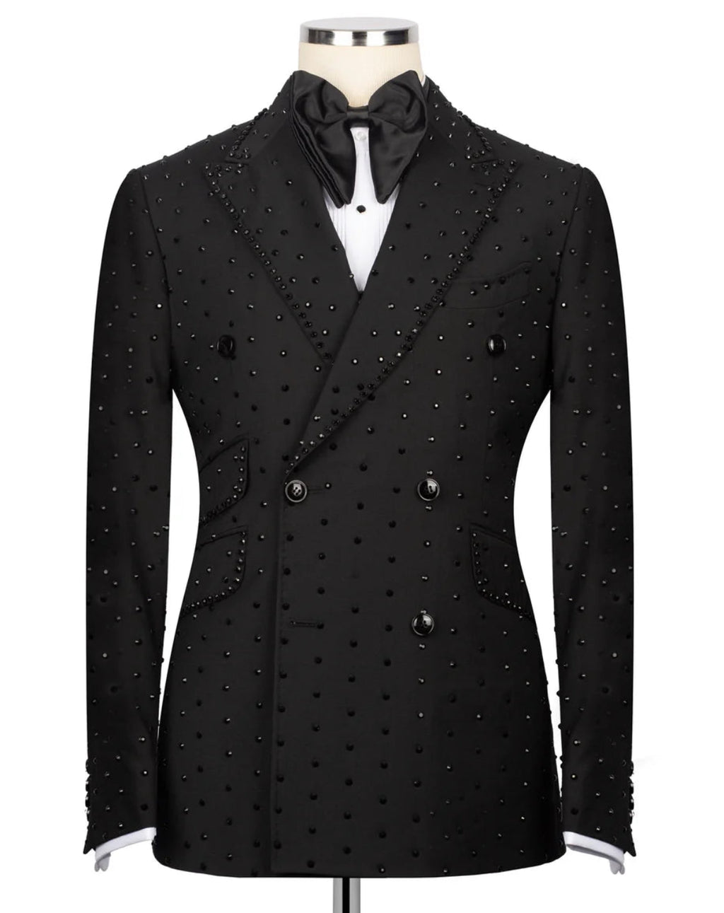 A black double-breasted tuxedo jacket embellished with small silver studs, displayed on a mannequin with a black bow tie and white shirt.