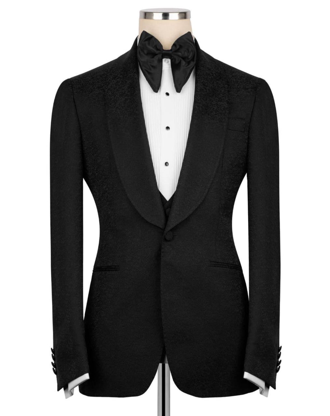 Black tuxedo jacket on a mannequin with a white shirt and bow tie