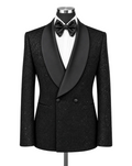 A black double-breasted tuxedo jacket with a textured glitter finish, featuring wide black satin shawl lapels, styled on a mannequin with a white dress shirt and black bow tie against a plain white background.
