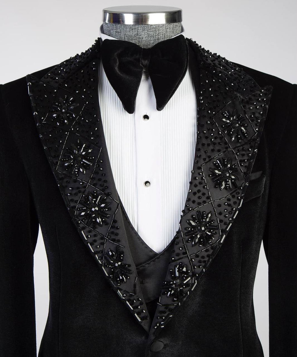 Black tuxedo with decorative lapels on a mannequin against a white background