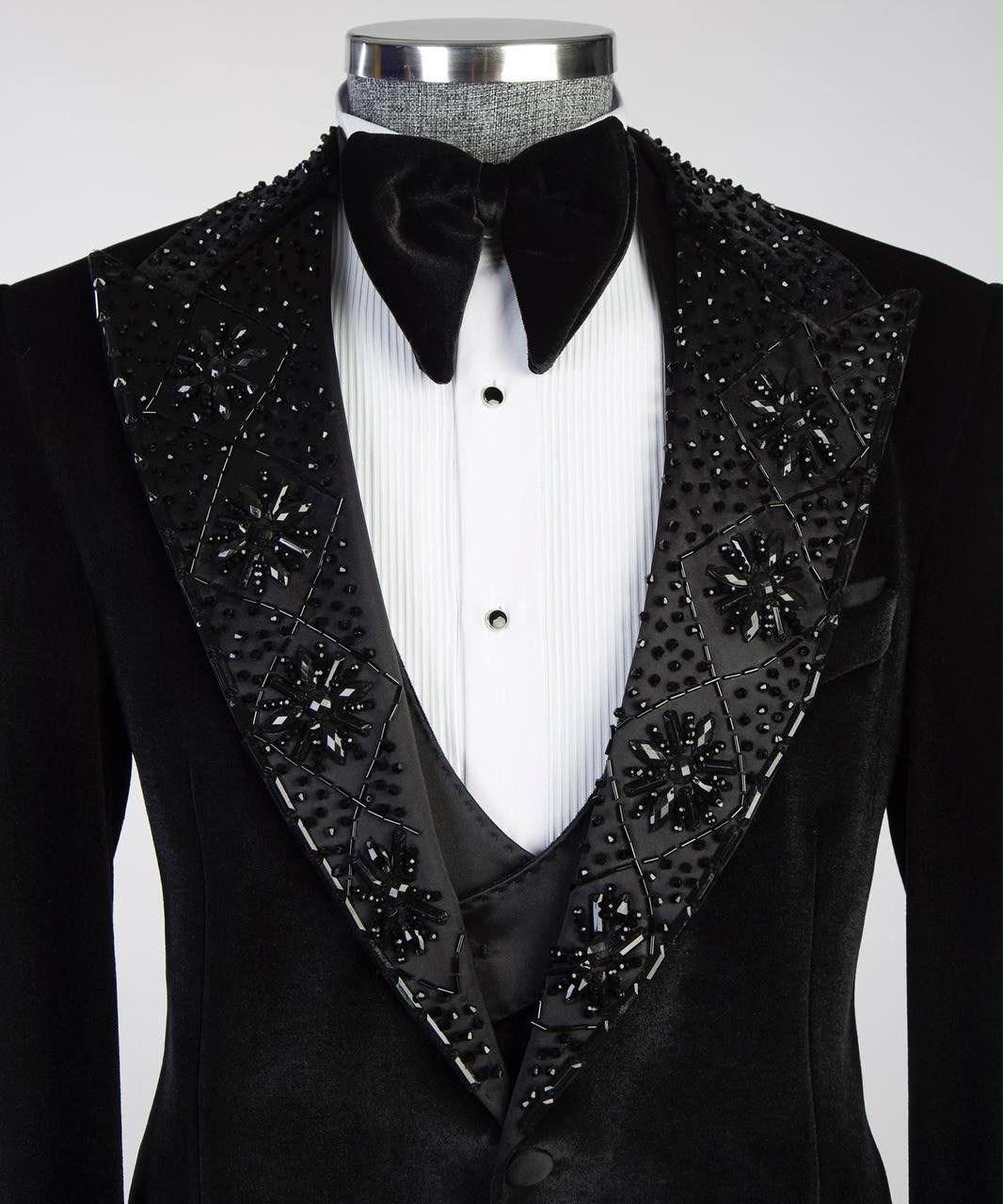 Black tuxedo with decorative lapels on a mannequin against a white background