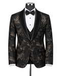 A men's tuxedo jacket displayed on a mannequin torso, featuring a black and gold floral brocade pattern with black satin shawl lapels, styled with a white pinstripe shirt, black bow tie, and matching vest.